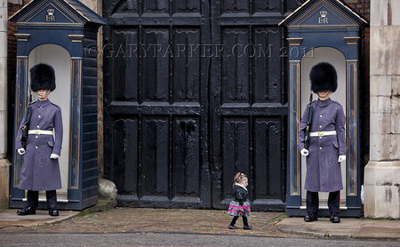 Bridgette Jordan, 22, a 19 pound college cheerleader & America's Shortest Lady at under 27" tall, succeeds in unnerving the steely-eyed gaze of the Queen's Guards at Buckingham Palace, during a recent trip to London.